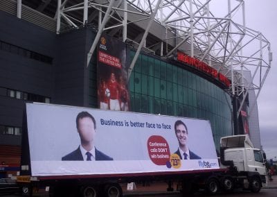 Flybe Face to Face 96-sheet AdTrailer promoting business air travel outside Old Trafford Manchester